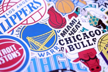 KYIV, UKRAINE - 23 Şubat 2025 NBA basketbol takımlarının birçok kağıt amblemi büyük bir yığın içinde uzanır.