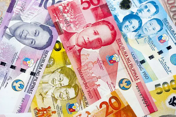 Filipinler Peso para birimi faturaları. Mevcut banknotlar masanın üzerinde büyük miktarda yatıyor.