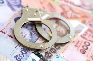 Tayland baht para birimi faturaları ve kelepçeler kapanıyor. Suç kavramı