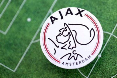 KYIV, UKRAINE - 23 Şubat 2025 AFC Ajax futbol kulübü rozeti futbol sahasının arka planında yer alıyor