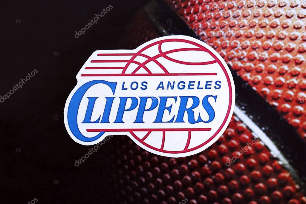 KYIV, UKRAINE - FEBRUARY 23, 2025 Los Angeles Clippers basketball team badge lies on basketball ball background banner