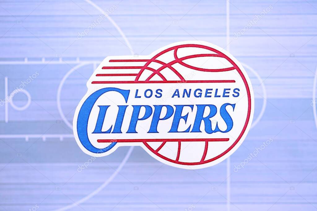 KYIV, UKRAINE - FEBRUARY 23, 2025 Los Angeles Clippers basketball team badge lies on basketball stadium map background banner