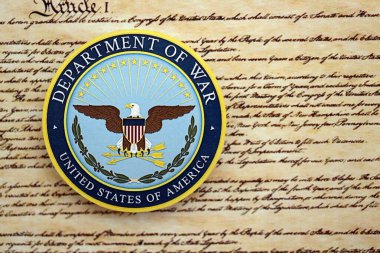 KYIV, UKRAINE - SEPTEMBER 17, 2025 US Department of War badge on first page of US Constitution replica close up