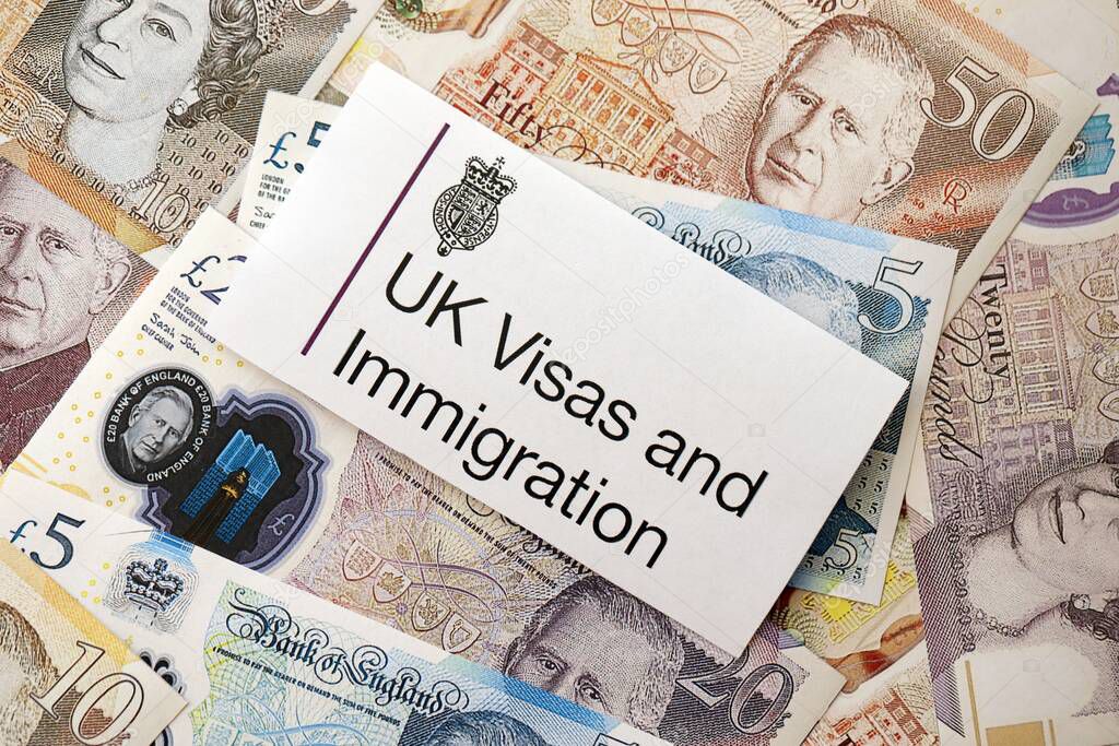KYIV, UKRAINE - SEPTEMBER 17, 2025 UK Visas and Immigration logotype sticker lies on British pound money close up