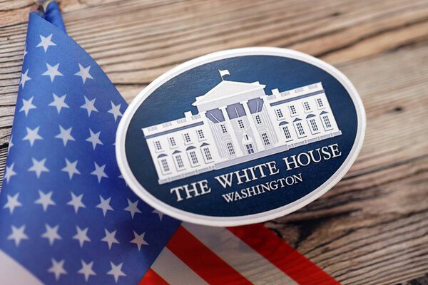 KYIV, UKRAINE - SEPTEMBER 17, 2025 US LAPD Police officer badge with flag on wooden table close up