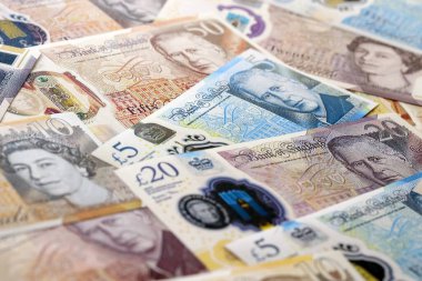 KYIV, UKRAINE - SEPTEMBER 17, 2025 Big amount of British pound money bills on table close up