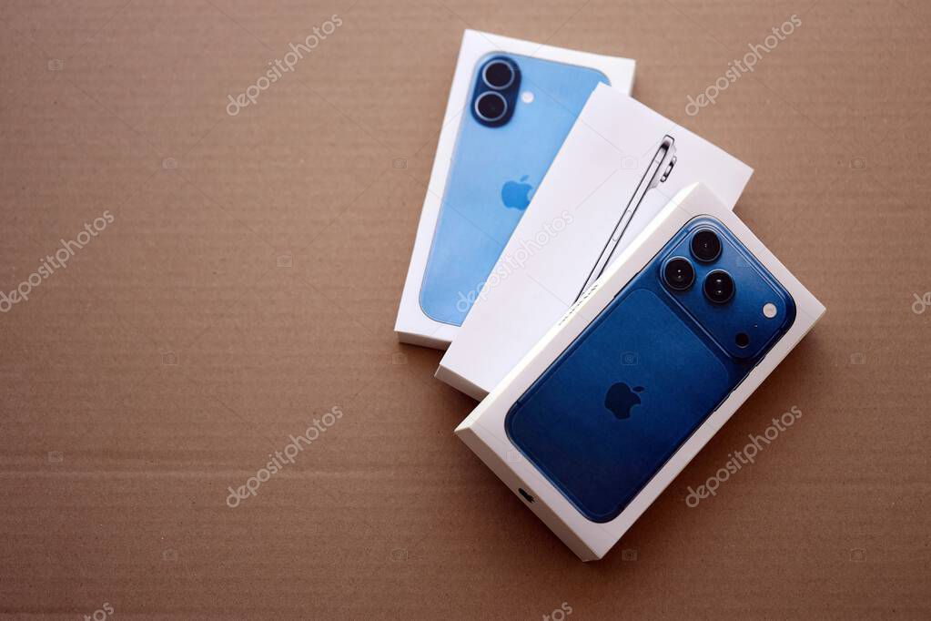 KYIV, UKRAINE - SEPTEMBER 21, 2025 Apple iPhone 17 Pro Max Deep Blue box and other iPhone model box on cardboard surface close up