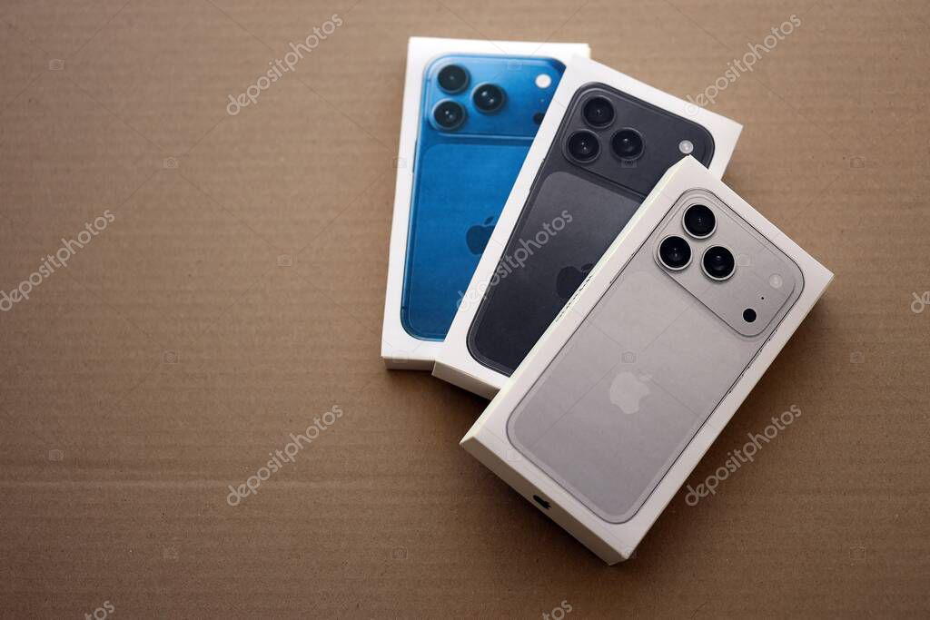 KYIV, UKRAINE - SEPTEMBER 21, 2025 Apple iPhone 17 Pro Max Silver box and other iPhone model box on cardboard surface close up