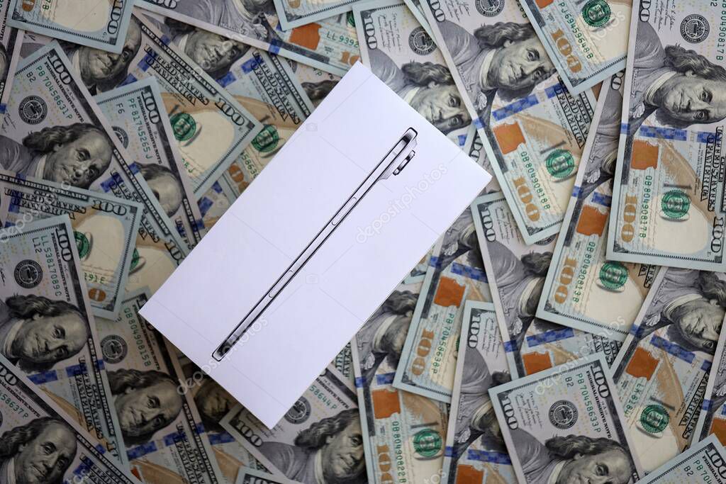 KYIV, UKRAINE - SEPTEMBER 21, 2025 Apple iPhone 17 Slim box on big amount of US dollar bills close up
