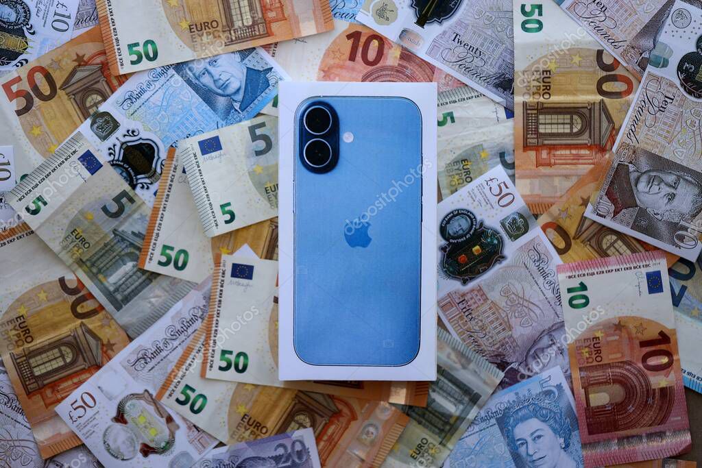 KYIV, UKRAINE - SEPTEMBER 21, 2025 Apple iPhone 17 Mist Blue box on big amount of GB pounds and euro bills close up