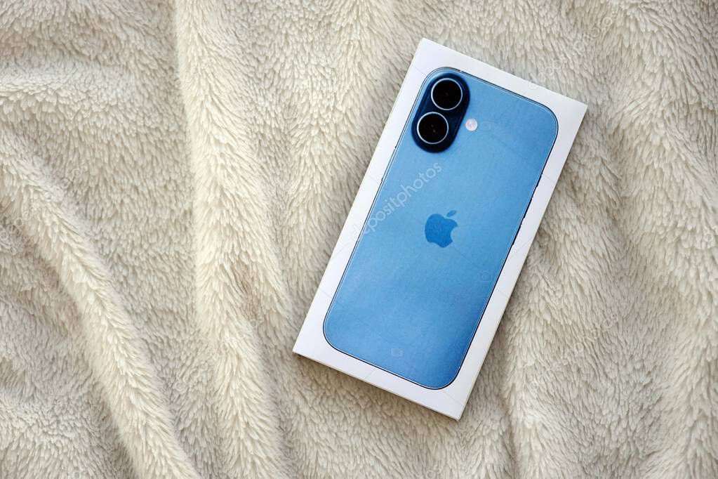 KYIV, UKRAINE - SEPTEMBER 21, 2025 Apple iPhone 17 Mist Blue box on fluffy white plaid close up