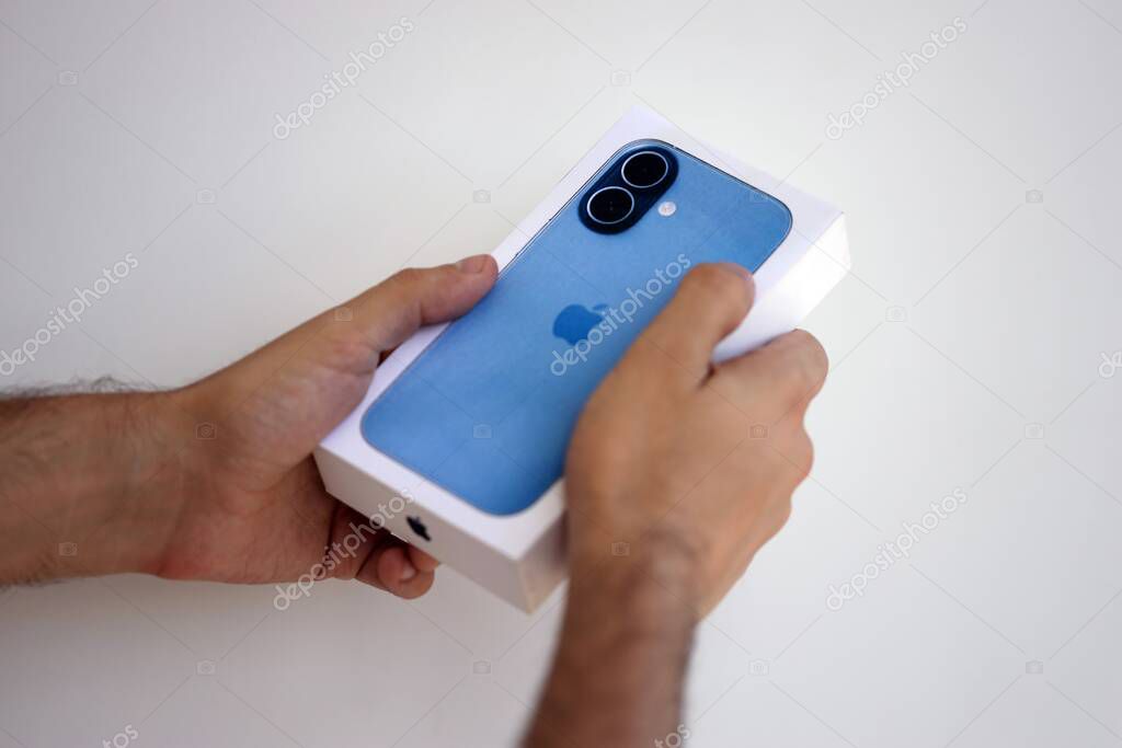 KYIV, UKRAINE - SEPTEMBER 21, 2025 Apple iPhone 17 Mist Blue box in male hands in shop close up