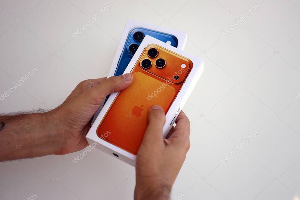 KYIV, UKRAINE - SEPTEMBER 21, 2025 Apple iPhone 17 Pro Max Cosmic Orange box in male hands in shop close up