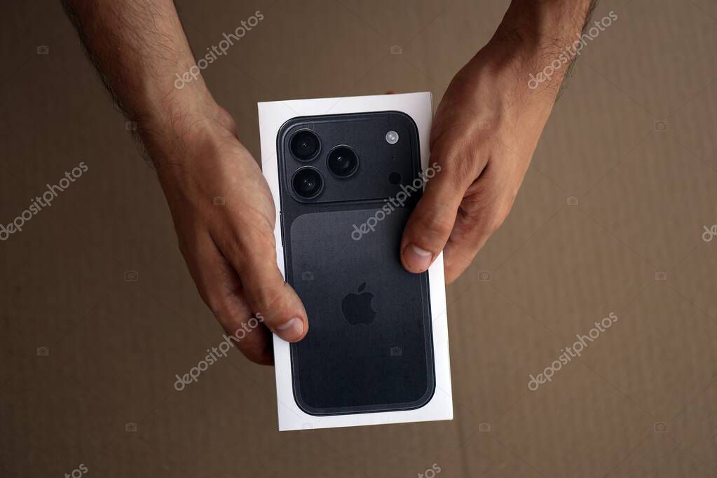 KYIV, UKRAINE - SEPTEMBER 21, 2025 Apple iPhone 17 Pro Max Black box in male hands on table close up