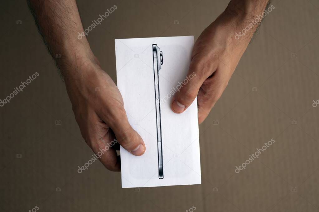 KYIV, UKRAINE - SEPTEMBER 21, 2025 Apple iPhone 17 Slim box in male hands on table close up