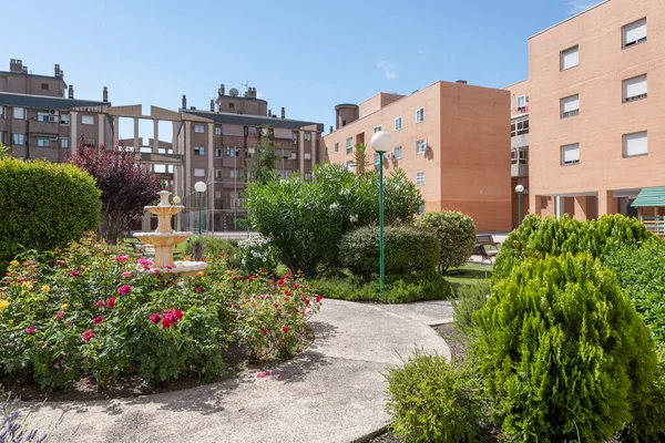 Views of buildings and common areas landscaped with flowers of an urban residential housing estate