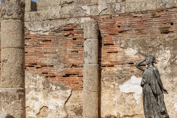 Bronze statue of the actress Margarita Xirgu between columns and walls of the majestic Roman theater of Merida in Badajoz, Spain