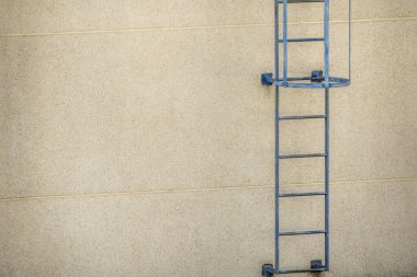 blue metal service ladder on a roof top rooftop