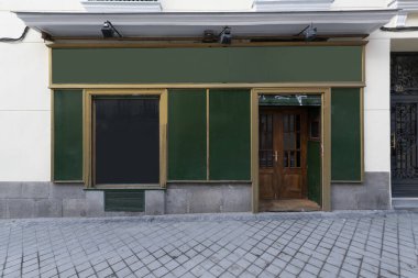 Vintage room with gilt wood frame and green paneling and wooden front door