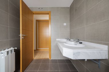 Bathroom of a recently built house to which the furniture and mirrors still have to be installed