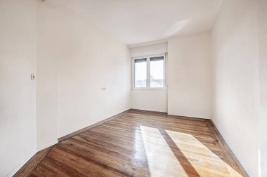 Empty room with varnished vintage wooden floors and plain walls