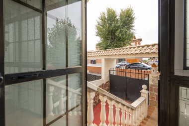 Stairs of a detached house with black gate entrance to the garage ramp