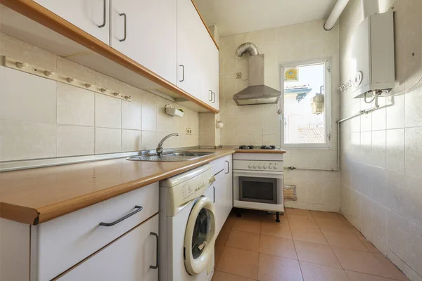 Used kitchen from a cheap apartment with natural gas boiler and gas cooker