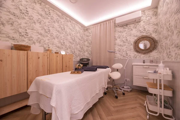 Cabin with massage table and treatments of a beauty salon and aesthetic care