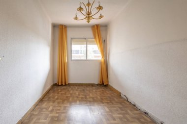 Empty room with sintasol floors, white painted walls with gotelet and aluminum window with yellow curtains