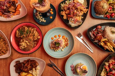 Set of recipes for typical Peruvian food, anticuchos, fish jelly, lomo saltado, arroz chaufa, cancha, fish, plantains, lime cause, salty noodles, rice and leche de tigre