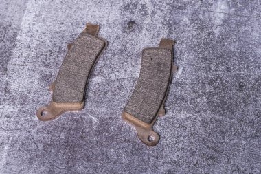 Brand new motorcycle brake pads with ferodo on a gray surface