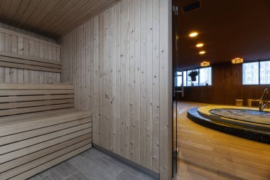 A two-level Finnish sauna to have a good time of sweaty relaxation next to a jacuzzi in a therapeutic massage center