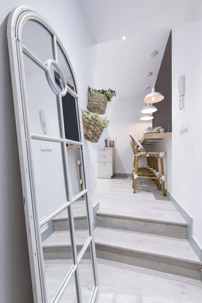 Hallway of a vacation rental home decorated with a full-length mirror with bars leaning against the wall