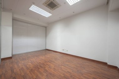 An empty office with technical ceilings that support an air conditioner