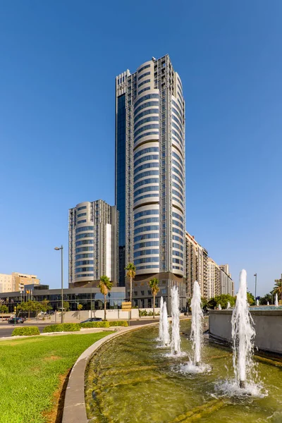 stock image A tall building with a hotel and offices with curved facades with metal and glass