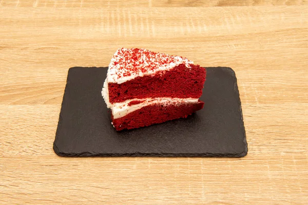 A red velvet cake is a chocolate cake with a deep red or bright red color. Usually prepared as a layered cake covered in a cream cheese glaze or cooked roux