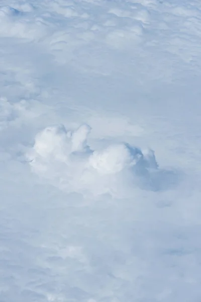 A cloud is a visible hydrometeor formed by the accumulation of ice crystals and/or microscopic water droplets suspended in the atmosphere, as a result of the condensation of water vapor