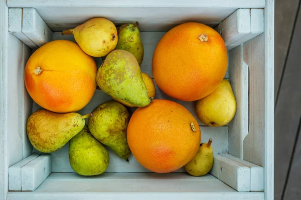 Fruit crate with grapefruits and pears of various varieties