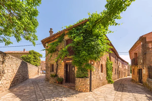 stock image Some beautiful stone houses and streets of the same pavement in an old town in Castilla