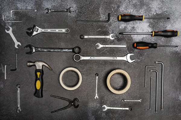 open-end wrenches, Phillips screwdrivers, masking tape, hammers, and other simple tools
