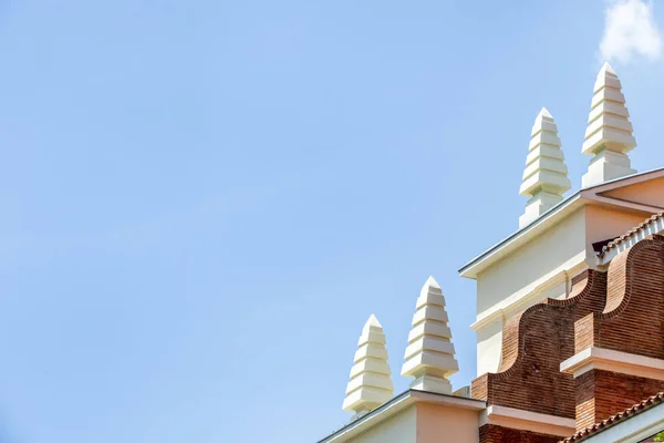 stock image Roofs of a vintage building with white painted concrete pyramidal ornaments