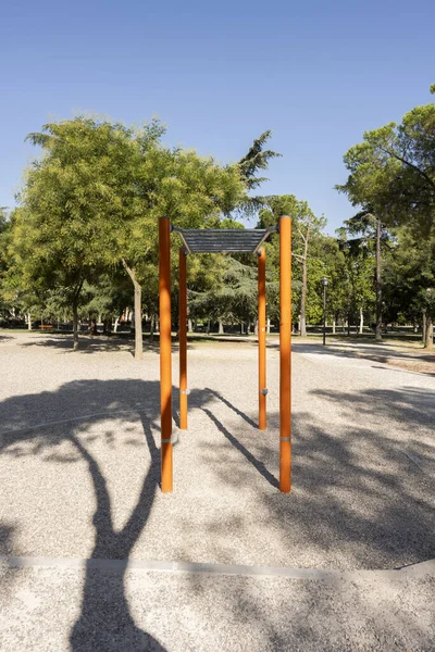 A flight of metal elevated training stairs in an urban park