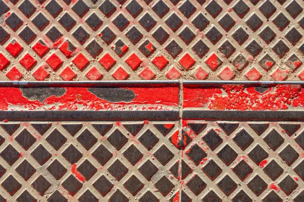 Metal stair treads with peeling red paint