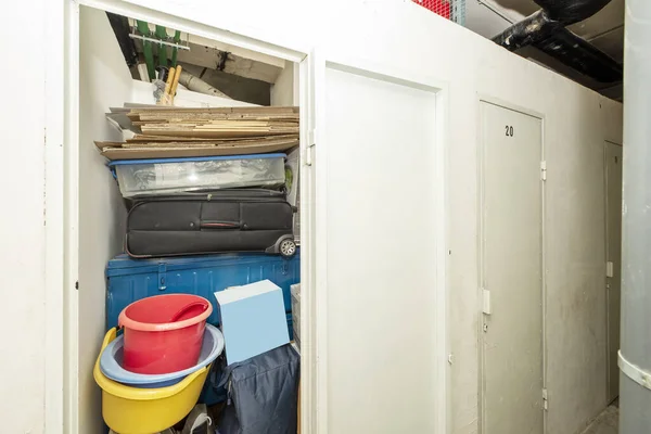 A storage room of a house full of suitcases and objects