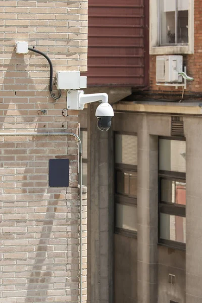 Security and surveillance cameras installed on a street corner