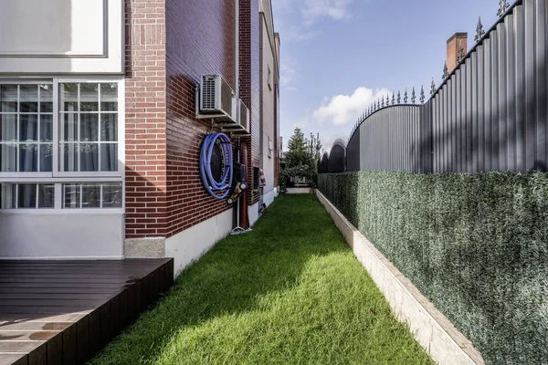 Small elongated plot of grass that surrounds the perimeter of a single-family home