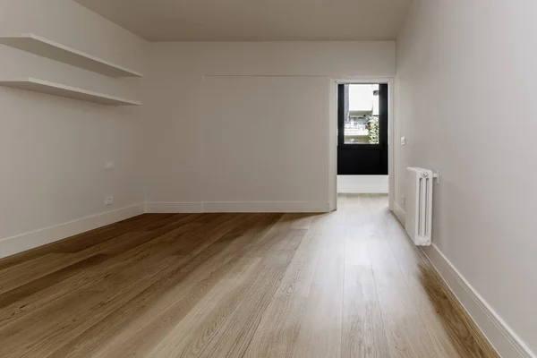 Empty bedroom with white wooden shelves on the wall, French oak floors