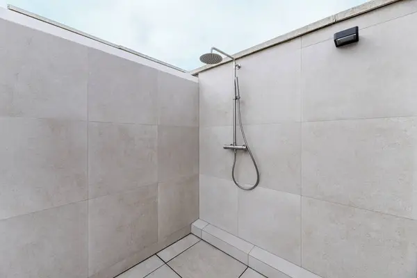 An outdoor shower on the terrace of an attic home