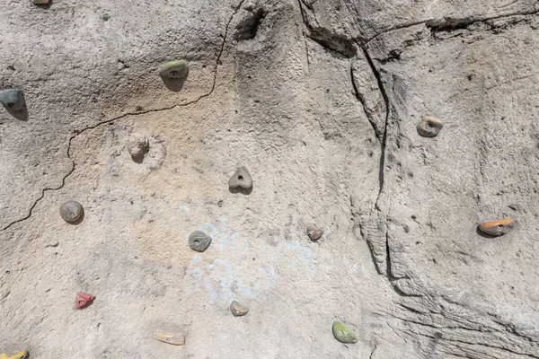 An outside rock with climbing holds for training.