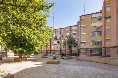 Kentsel yerleşim alanlarında tuğla ve taşlarla inşa edilmiş yükseltilmiş ağaç kuyuları olan bir yerleşim alanının kaldırımlı geçidi.